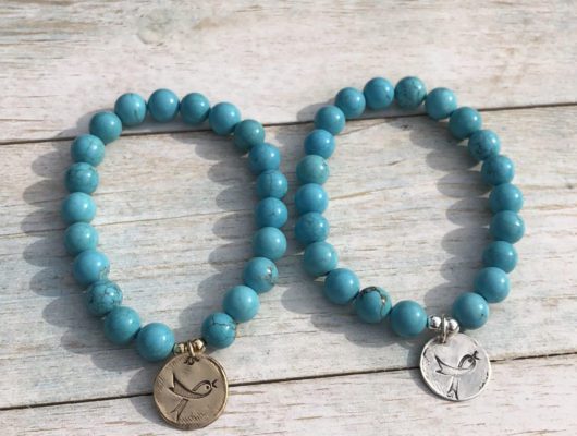 Two turquoise bead bracelets with bird charms.